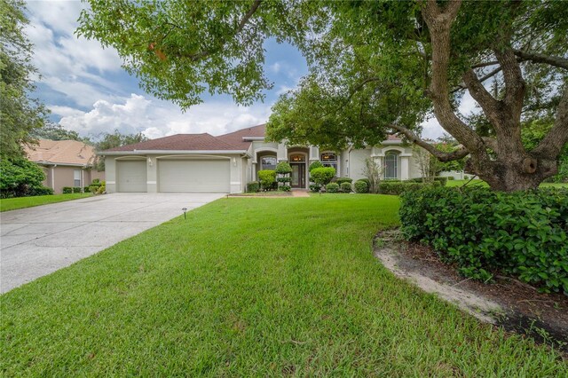 view of front of property with a garage and a front lawn