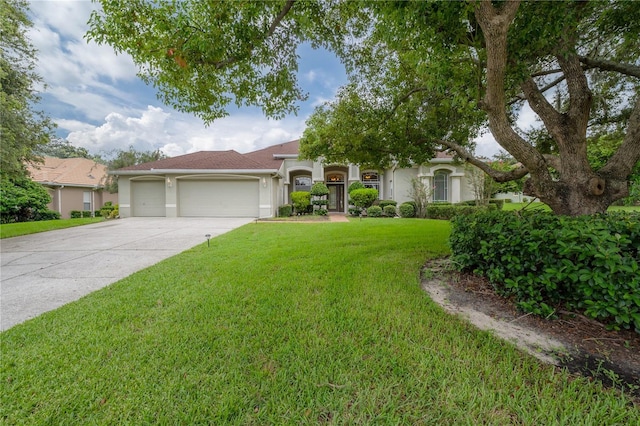 view of front of house with a front yard, stucco siding, concrete driveway, and a garage