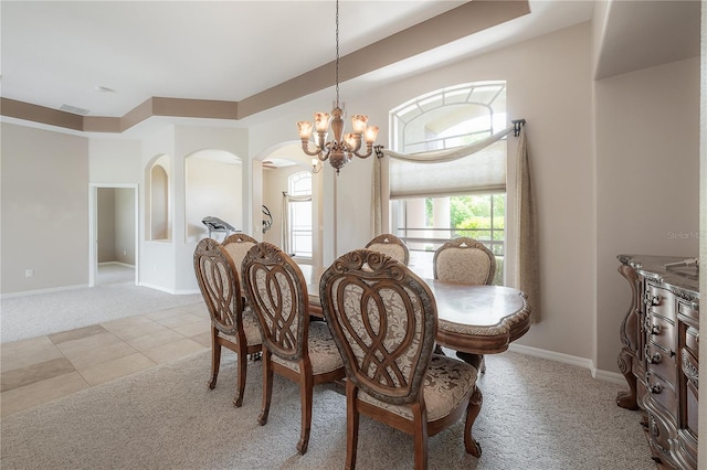 carpeted dining space featuring an inviting chandelier