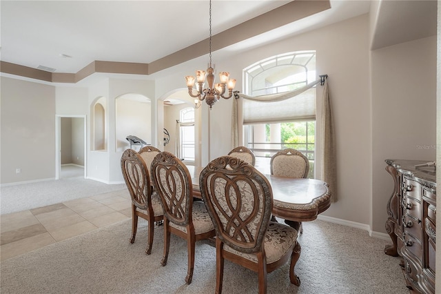 dining area with light tile patterned floors, light carpet, baseboards, and a notable chandelier