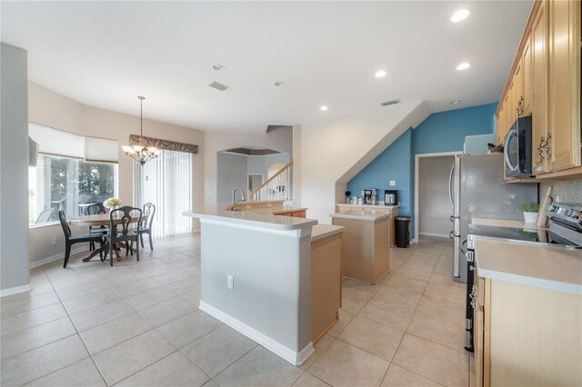 kitchen featuring light tile patterned flooring, a chandelier, range with electric stovetop, hanging light fixtures, and a center island with sink