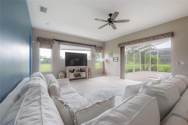 living area with carpet floors, baseboards, visible vents, and ceiling fan