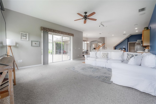 living area with light colored carpet, baseboards, ceiling fan with notable chandelier, visible vents, and recessed lighting