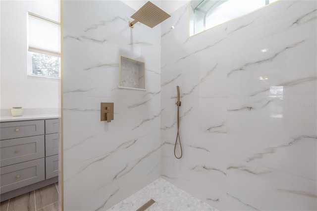 bathroom with a marble finish shower
