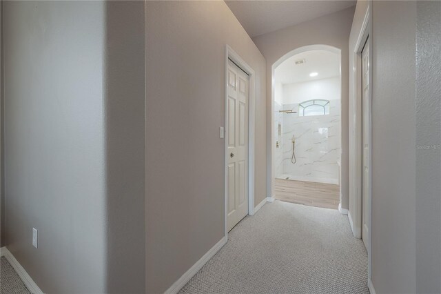 hallway featuring light carpet