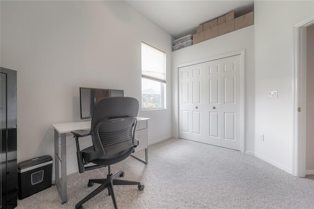 carpeted office space featuring baseboards