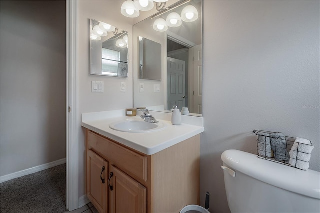 bathroom with baseboards, toilet, and vanity