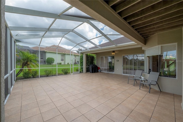 unfurnished sunroom featuring ceiling fan