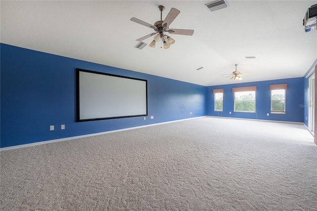 carpeted cinema room featuring ceiling fan and lofted ceiling