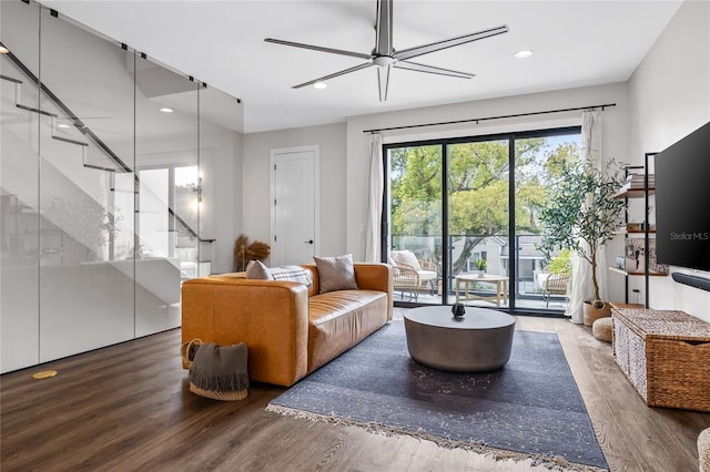 living room with stairway, wood finished floors, and recessed lighting