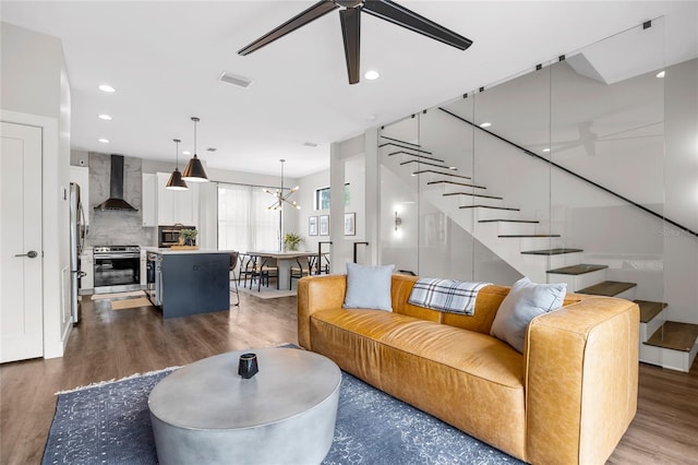 living area with stairs, visible vents, wood finished floors, and recessed lighting