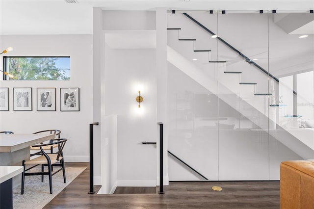 stairway with baseboards and wood finished floors