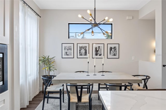 dining area featuring an inviting chandelier and wood finished floors