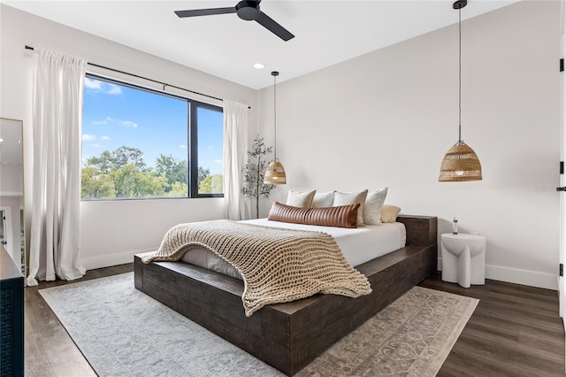 bedroom featuring ceiling fan, recessed lighting, dark wood finished floors, and baseboards