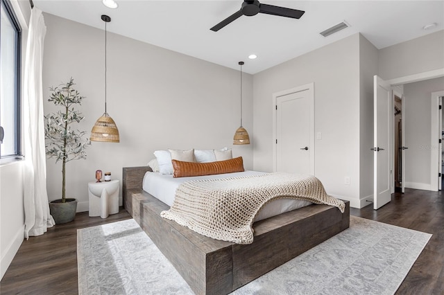 bedroom with baseboards, visible vents, dark wood-type flooring, and recessed lighting