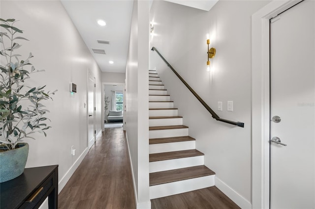 stairs with visible vents, baseboards, wood finished floors, and recessed lighting