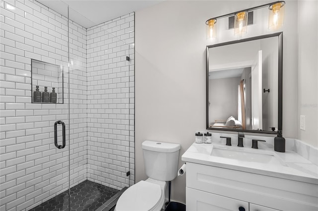 full bathroom featuring toilet, a stall shower, and vanity