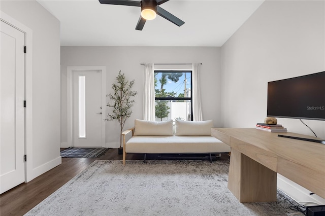 interior space featuring dark wood-type flooring, baseboards, and a ceiling fan