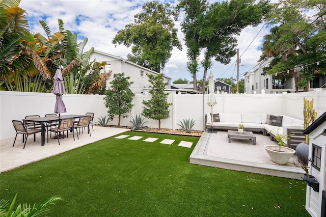 view of yard featuring a patio, a fenced backyard, and an outdoor living space