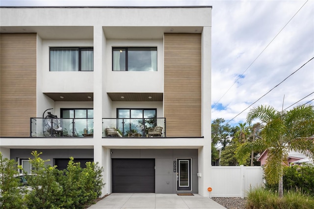 view of front of home featuring a garage and a balcony