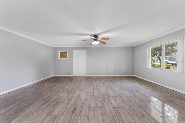 empty room featuring ceiling fan, crown molding, and light hardwood / wood-style floors