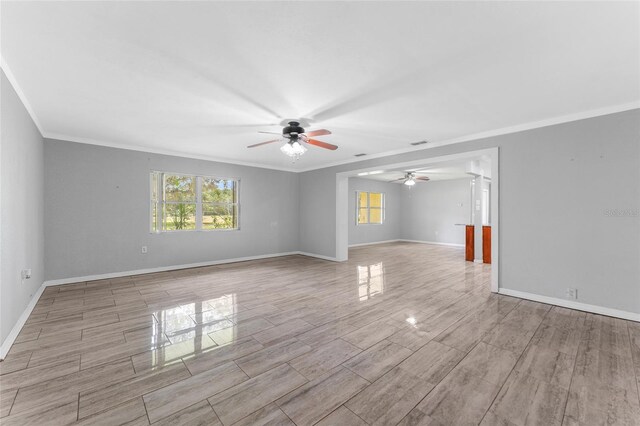 unfurnished room with ceiling fan and ornamental molding