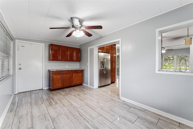 kitchen with ceiling fan, stainless steel refrigerator with ice dispenser, and hanging light fixtures