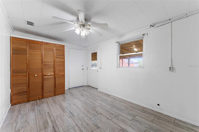 unfurnished bedroom with ceiling fan and light wood-type flooring