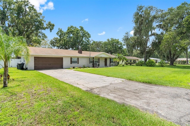 single story home featuring a garage and a front yard