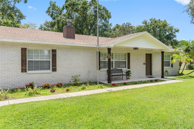 ranch-style home with a front lawn