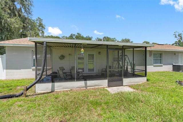 back of house featuring central air condition unit, a patio area, and a lawn