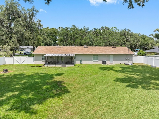 back of house with a lawn