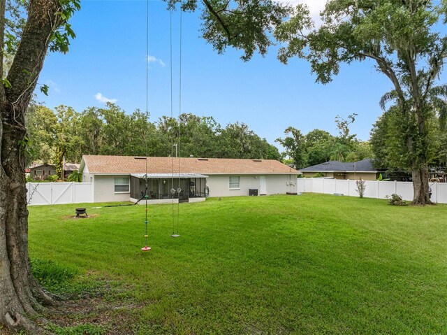 rear view of house featuring a yard