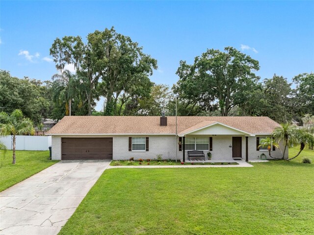 single story home with a front yard and a garage