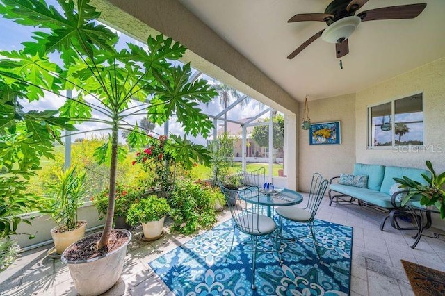 view of patio / terrace featuring ceiling fan and a lanai