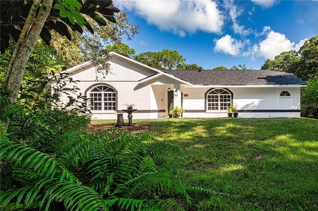 view of front of property with a front yard and stucco siding