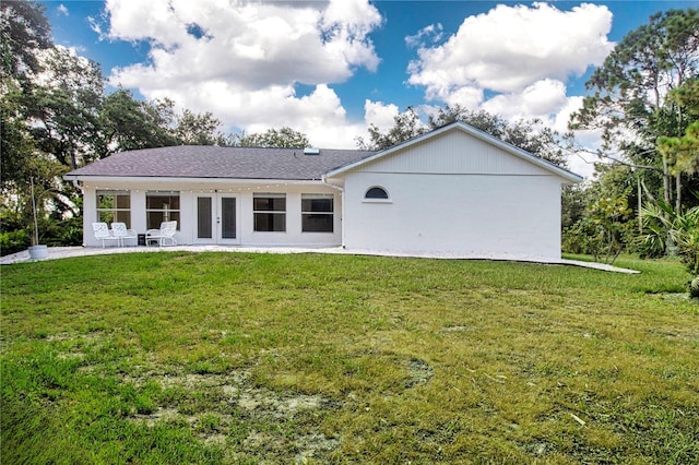 back of property featuring french doors, a patio area, and a yard