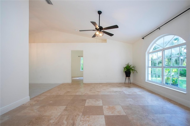 empty room featuring ceiling fan, visible vents, baseboards, and vaulted ceiling