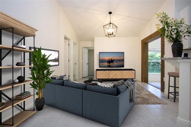 tiled living room featuring lofted ceiling and a chandelier