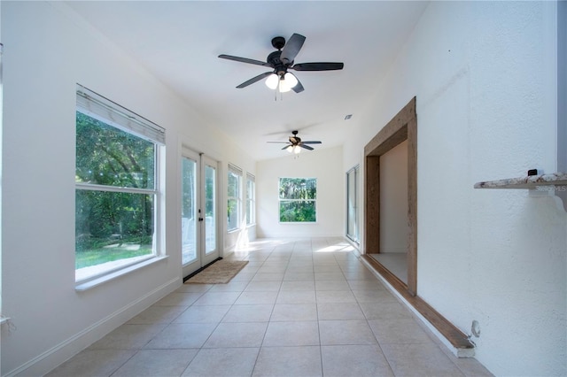 hallway with light tile patterned floors and french doors