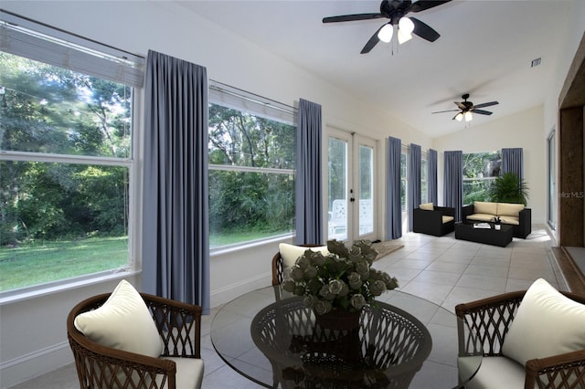 sunroom with a ceiling fan, lofted ceiling, visible vents, and plenty of natural light