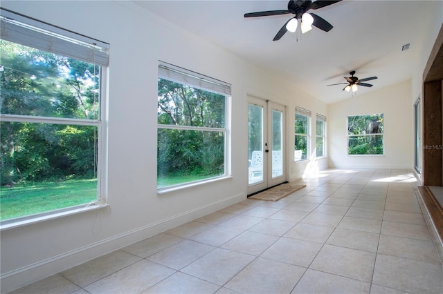 tiled empty room with ceiling fan and french doors