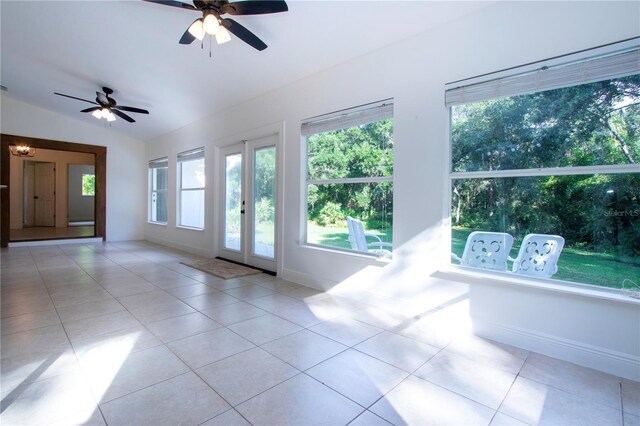 tiled empty room with ceiling fan and french doors