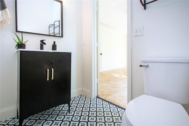 bathroom with tile patterned flooring, toilet, and vanity