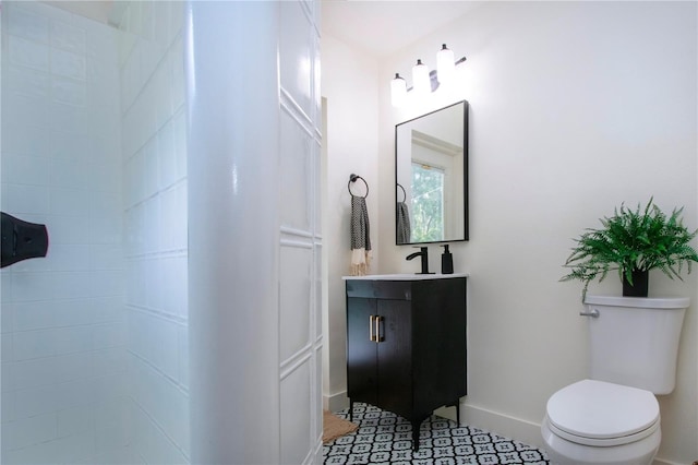 bathroom featuring tile patterned flooring, vanity, and toilet