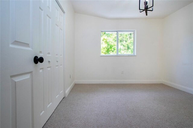 empty room with carpet floors and baseboards