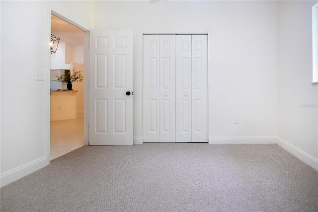 unfurnished bedroom with carpet floors and a closet