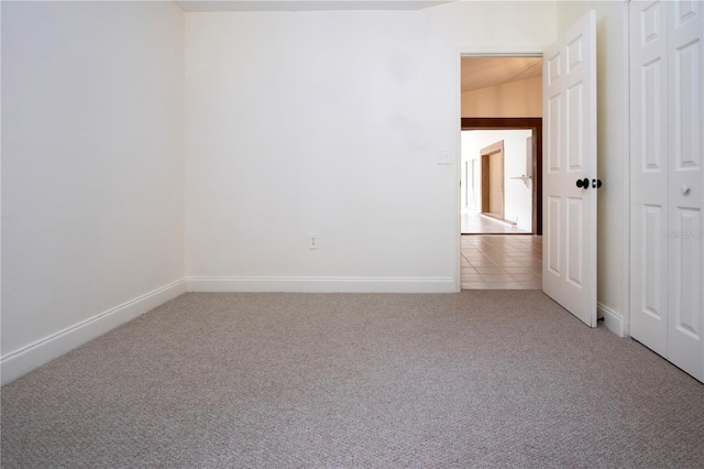 empty room with carpet floors and lofted ceiling