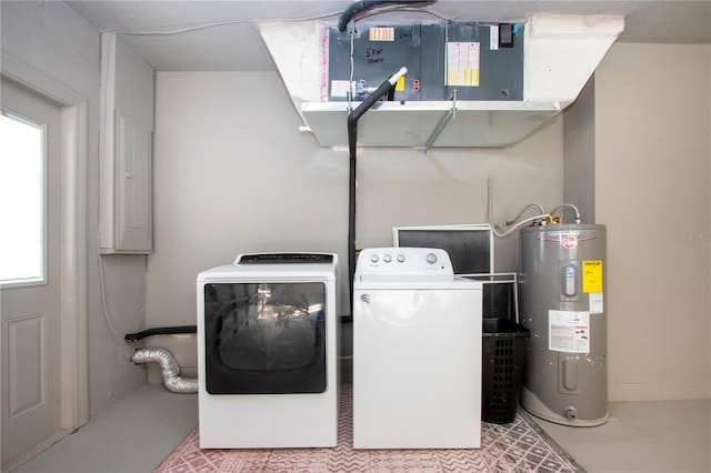 washroom featuring independent washer and dryer, light tile patterned floors, and electric water heater