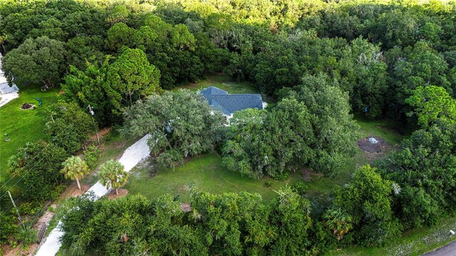 drone / aerial view with a wooded view